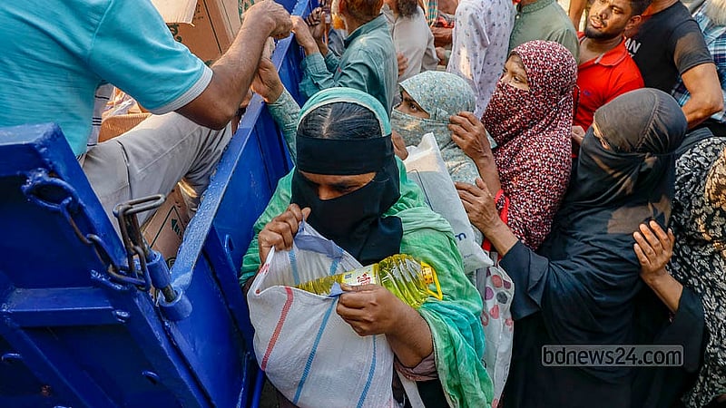 Near the Town Hall of Dhaka’s Mohammadpur, buyers stand in line for hours in the scorching sun on Wednesday, Feb 18, 2026, to buy products from Trading Corporation of Bangladesh (TCB) trucks, as they offer daily necessities at a lower price. Photo: Mahmud Zaman Ovi
