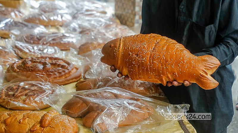 A vendor holds patterned bread in Old Dhaka’s Chawkbazar, on the occasion of Shab-e-Barat on Tuesday, Feb 3, 2026. Photo: Abdullah Al Momin