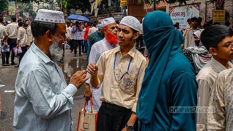 Examinees discuss their HSC test with their parents and guardians outside the examination centre on Sunday, Jun 30, 2024, the first day of the public exams. Photo: Mahmud Zaman Ovi