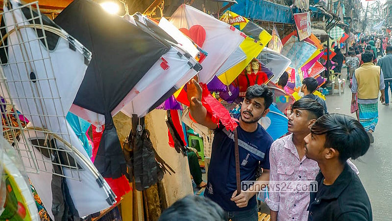 A buyer looks at kites at Shankhari Bazaar, where polythene kites are sold alongside traditional paper ones. Photo: Abdullah Al Momin