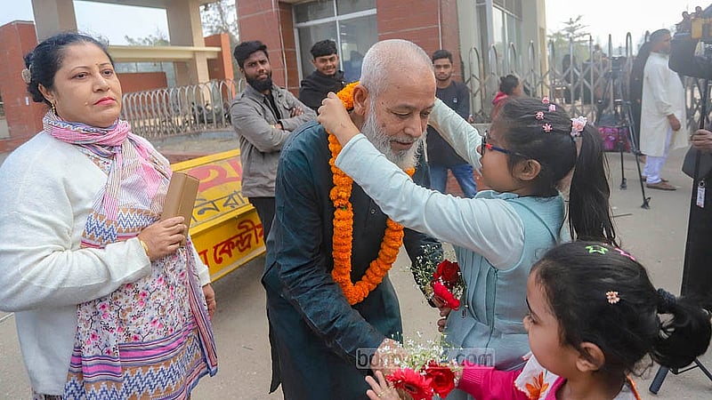 BDR Engineer Corps member Muzaffar Hossain becomes emotional as he hugs his two grandsons, one of whom garlands him. Photo: Abdullah al Momin