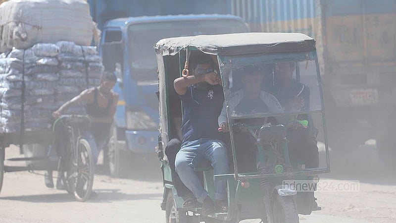 Walking in the 11km stretch of Babubazar-Gabtoli Beribadh Road is a struggle against dust. Photo taken in Islambagh. Photo: Abdullah al Momin