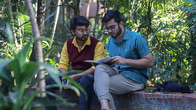 Students visiting Dhanmondi Lake read books from bookcases. After reading, they must leave the books in their original places. Photo: Abdullah al Momin