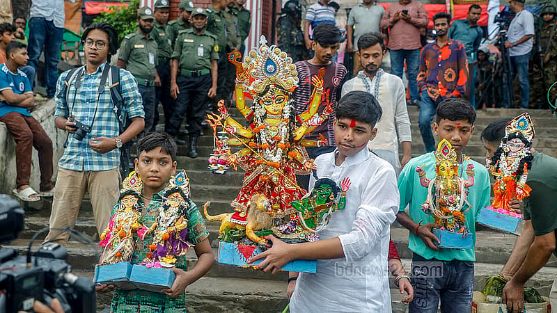 A small idol made of paper is brought from Nawabpur in Old Dhaka to the banks of the Buriganga River in Dhaka's Waizghat for immersion on Thursday, Oct 2, 2025. Photo: Abdullah Al Momin