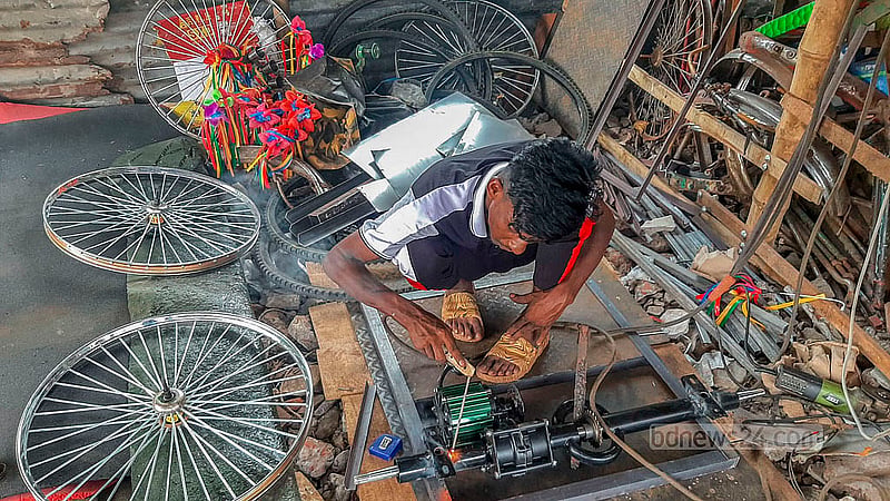 A workshop in Dhaka’s Rayerbazar is busy putting together battery-run rickshaws.