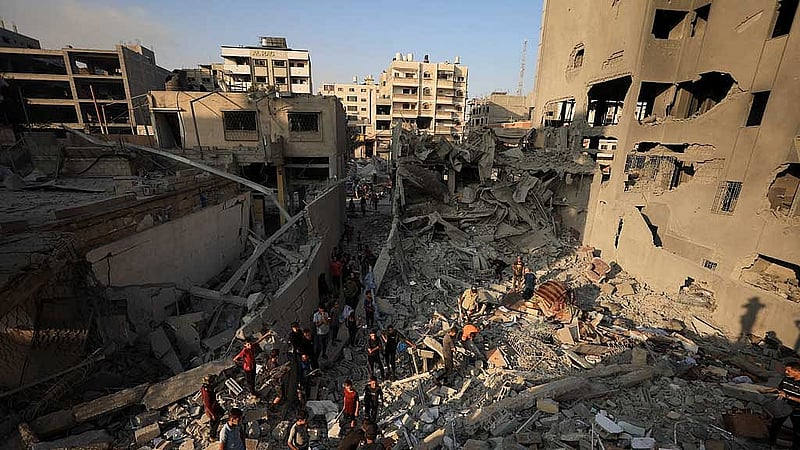 Palestinians inspect the damage at the site of Israeli strikes that destroyed Al-Jundi al-Majhoul residential tower on Sunday, in Gaza City, Sept 15, 2025. REUTERS
