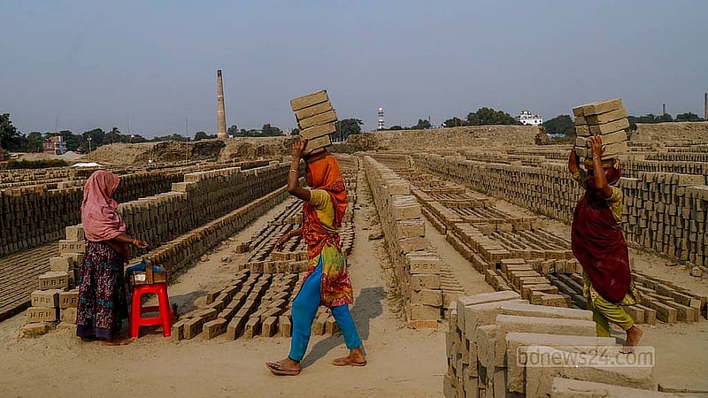 Bricks, dried in the sun, are being carried on heads to the kiln for firing. Women also perform the task of carrying them near the furnace. Photo: Mahmud Zaman Ovi