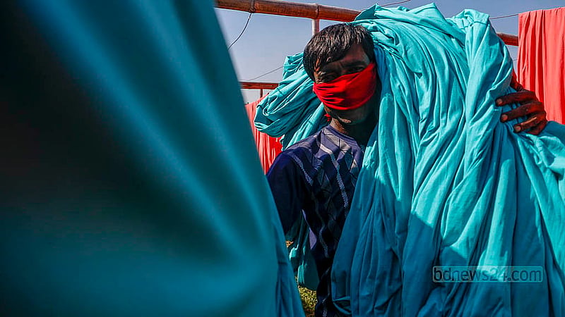 Dyed fabrics dry under the sun in an open field in Narayanganj’s Fatullah Post Office area.Photo: Mahmud Zaman Ovi