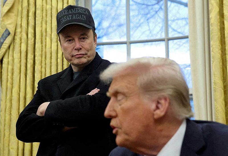 FILE PHOTO: Elon Musk listens to US President Donald Trump speak in the Oval Office of the White House in Washington, DC, US, February 11, 2025. REUTERS