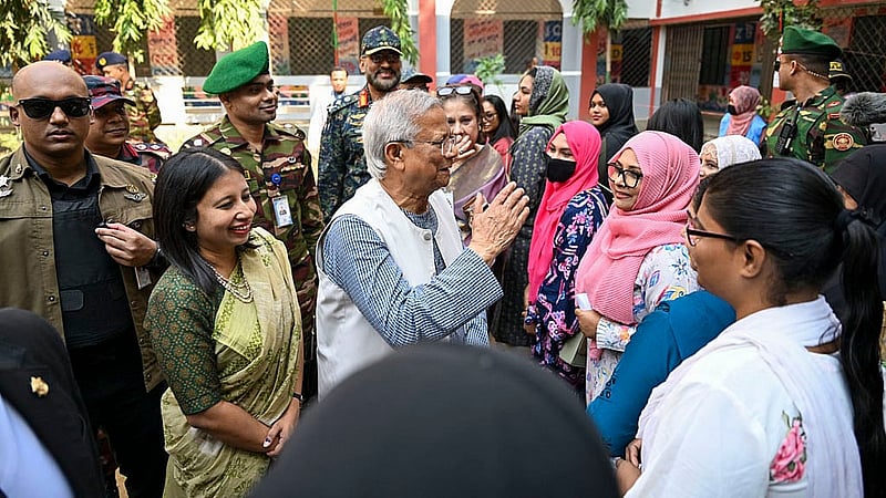 After voting at the Gulshan Model School and College centre, Muhammad Yunus speaks with voters outside the polling station. Photo: PID