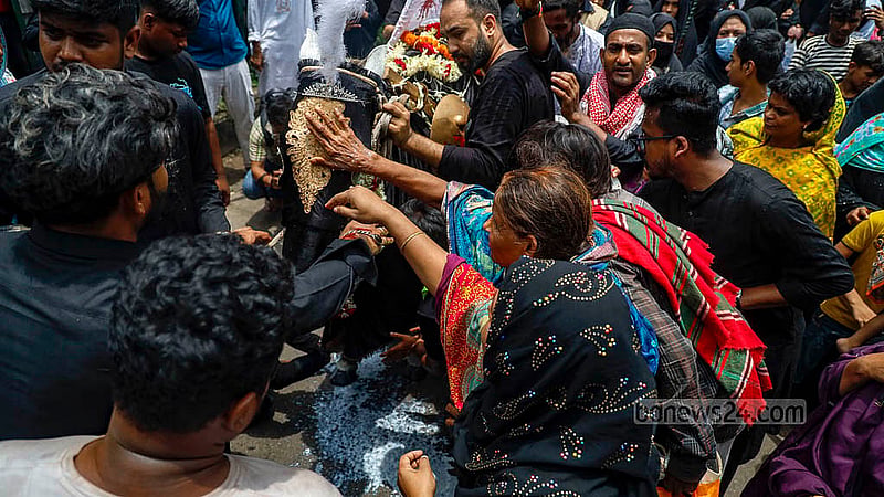 In the Tazia procession that started from Dhaka’s Hussaini Dalan on Sunday, Jul 6, 2025, a horse's feet are being washed with milk as per the custom. Photo: Mahmud Zaman Ovi