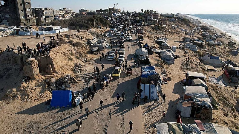 A drone view shows Palestinians, who were displaced to the southern part of Gaza at Israel's order during the war, making their way along a road to return to the north after a ceasefire between Israel and Hamas in Gaza went into effect, in the central Gaza Strip, October 10, 2025. REUTERS