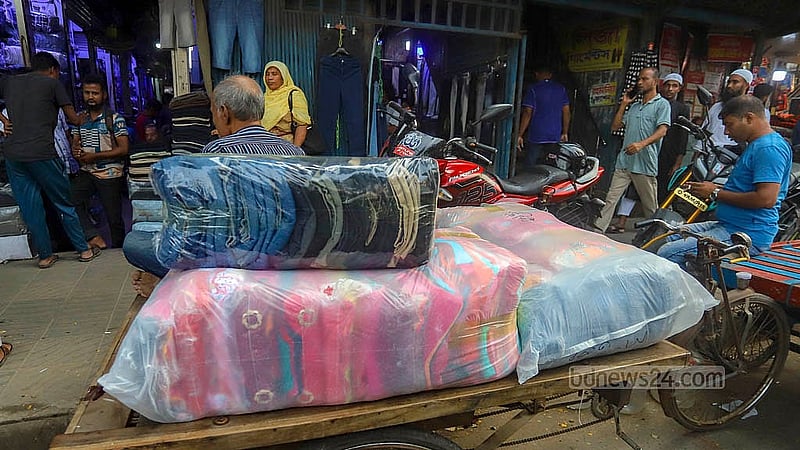 Customers carrying products in plastic packets from a wholesale market in Dhaka. Photo: Abdullah al Momin