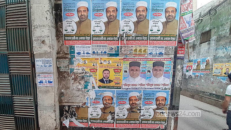 Candidates ignore the ban on paper posters for the national election campaign, pasting colourful posters on different walls across Old Dhaka. Photo: Abdullah Al Momin