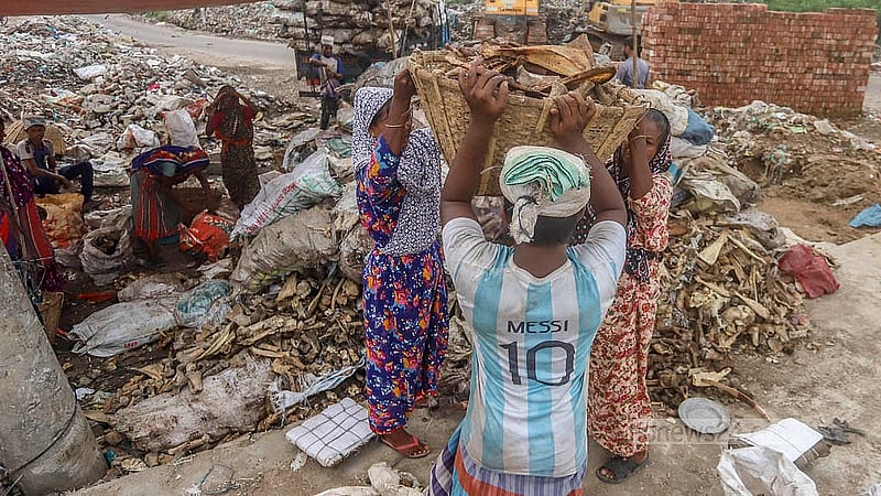 After sorting the animal bones, a worker carries them on his head into the factory. Photo: Abdullah al Momin