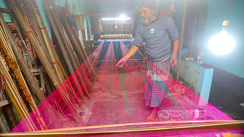After the thread is dyed, it is prepared to be used in weaving a sari. This process is called Bhim or Tana. This is the last stage of preparation and has to be done very carefully so it does not tear. Photo: Abdullah al Momin