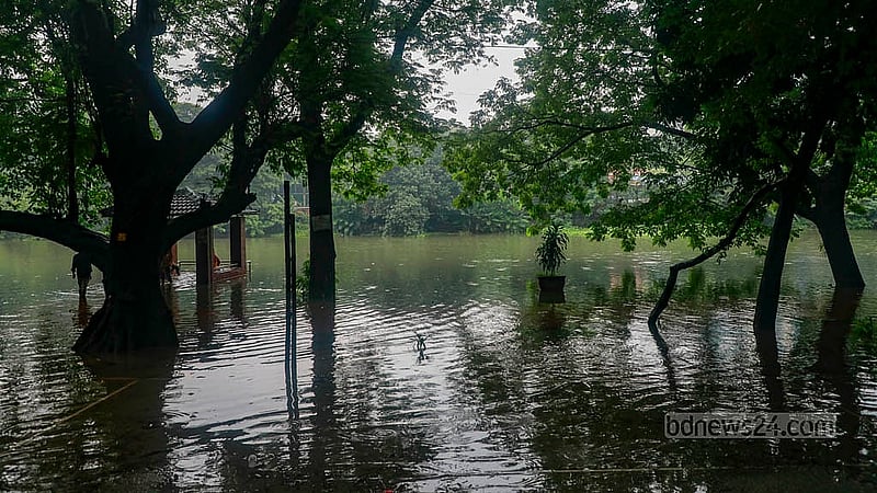 Due to waterlogging around Dhanmondi Lake, the walking paths have been submerged. Surroundings are inundated. Photo: Mahmud Zaman Ovi