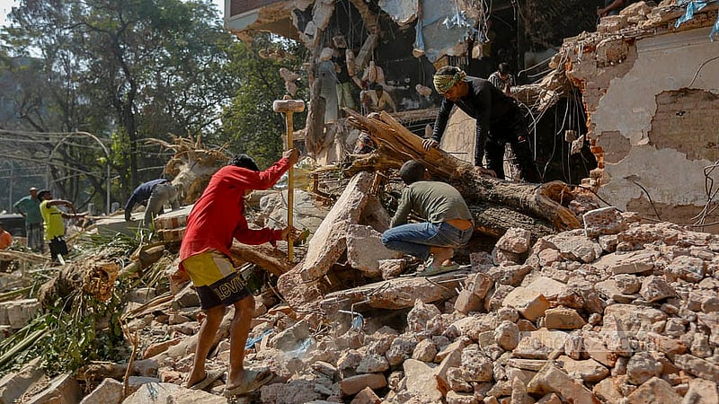 After the demolition of a part of Sheikh Mujib's house at Dhanmondi 32, iron and steel are being taken by everyone. Photo: Mahmud Zaman Ovi