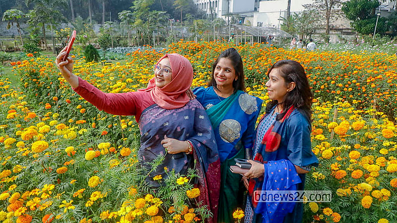 Many visitors are seen taking photographs with flowers during the festival at Ramna Park in Dhaka, organised by the Public Works Department. Photo: Abdullah al Momin