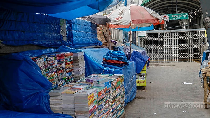 Hawkers have set up stalls underneath the metro rail station at Dhaka’s Mirpur-10. One such stall sells books. Photo: Mahmud Zaman Ovi