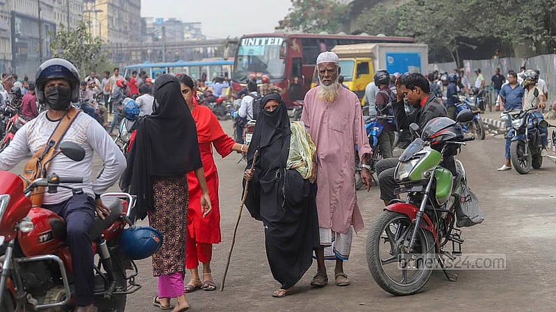 Commuters walk to their destinations on Monday, Mar 10, 2025, after traffic was halted at Chairman Bari U-turn in Banani, where garment workers blocked the road following the death of a female colleague in a road accident. Photo: Abdullah al Momin