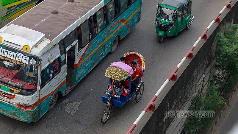 Battery-operated rickshaws navigate riskily alongside fast-moving vehicles on the busy Khilgaon flyover in Dhaka. Photo: Mahmud Zaman Ovi