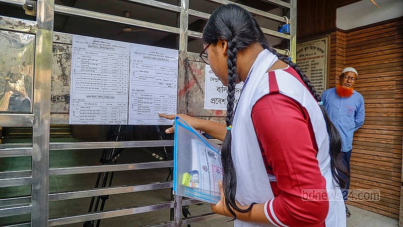 A student checks the seating arrangement at Motijheel Ideal School and College centre before the SSC exams begin on Thursday morning on Thursday, Apr 10, 2025. Photo: Mahmud Zaman Ovi