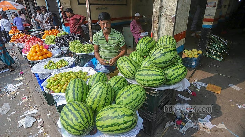 In a small roadside shop near Sadarghat, a vendor carefully arranges his watermelons, pricing each at Tk 400. Photo: Abdullah Al Momin