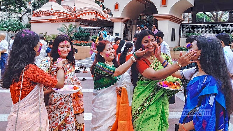 Smiles abound as devotees take part in the colourful Dol Purnima celebrations at the Dhakeshwari Temple on Friday, Mar 14, 2025. Photo: Abdullah al Momin