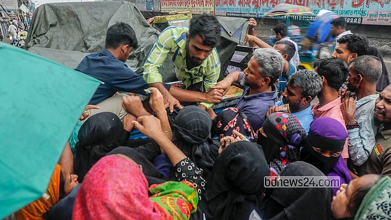 Buyers crowd around a vendor to collect subsidised goods from a TCB truck in Dhaka’s Jatrabari on Monday, May 11, 2026. Photo: Abdullah Al Momin