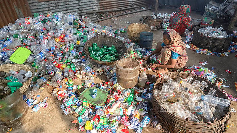 Workers at a plastic waste shop in Lalbagh sort through waste. Photo: Abdullah Al Momin