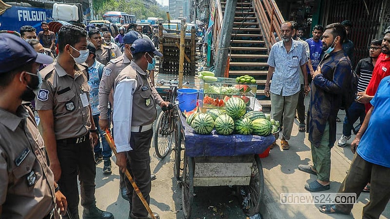 An eviction team clears illegal installations from the pavement on North South Road in Old Dhaka. Photo: Abdullah al Momin