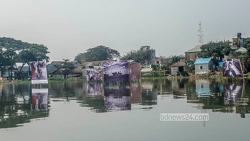 Seven photographs by Parvez Ahmed Rony displayed on a floating installation in the lake, with the Korail slums in the background, marking Felani Day and protesting border killings. Photo: Abdullah Al Momin