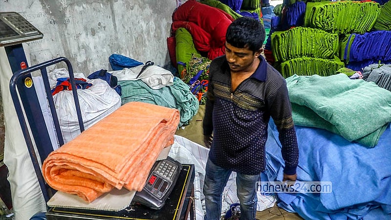 Fabrics for blankets are being measured on a scale after being cut to size in Siddhirganj, Narayanganj. A 5 to 6-foot-long blanket weighs about 2kg. Photo: Abdullah Al Momin