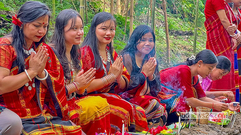 Tripura women and children pray on the banks of Khagrachhari's Chengi River on Hari Boisu. Photo: Samir Mallik