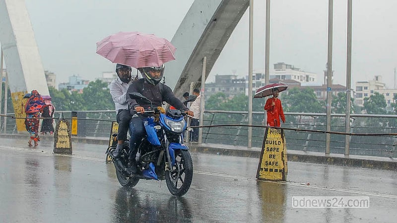 A man rides a motorcycle with an umbrella in the rain in Dhaka’s Hatirjheel on Monday, Mar 2, 2026. Photo: Abdullah Al Momin