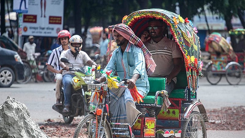 A rickshaw-puller has wrapped a “gamcha”, or local cotton towels around his head against the sun. Photo taken near Dhaka University on Monday, Aug 11, 2025. Photo: Abdullah al Momin