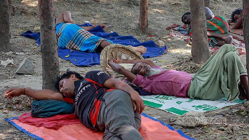Labourers take naps in the shade to escape the heat of the summer afternoon in Dhaka’s Gabtoli. Photo: Muhammad Mostafigur Rahman