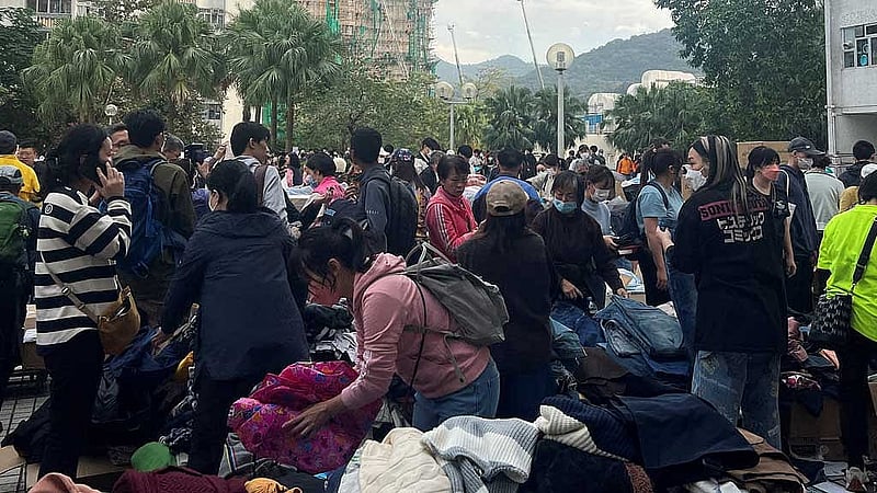 People sort and collect supplies outside an evacuation centre near the Wang Fuk Court housing complex, where a deadly fire erupted, in Hong Kong, China Nov 27, 2025. REUTERS/Mei Mei Chu