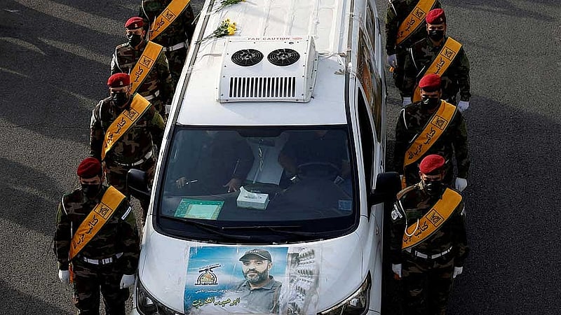 FILE PHOTO: A vehicle carries the coffin of a commander from Iraq's Kataib Hezbollah armed group who was killed in what they called a &amp;quot;Zionist attack&amp;quot; in the Syrian capital Damascus on Friday, during a funeral in Baghdad, Iraq September 22, 2024. REUTERS