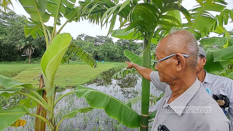 Only 15 percent remains of Thakurpara’s original 74-percent cremation ground. Village elder Mong Cho Wen indicates the portion that has been seized.