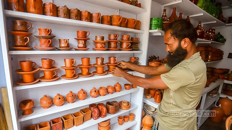 An employee arranging clay items at a pottery shop in the Farashganj area of Sutrapur, Dhaka. Photo: Abdullah Al Momin