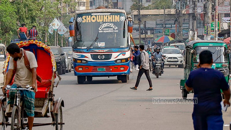 A bus from Mohakhali terminal stops in the middle of the road to take passengers in violation of rules.