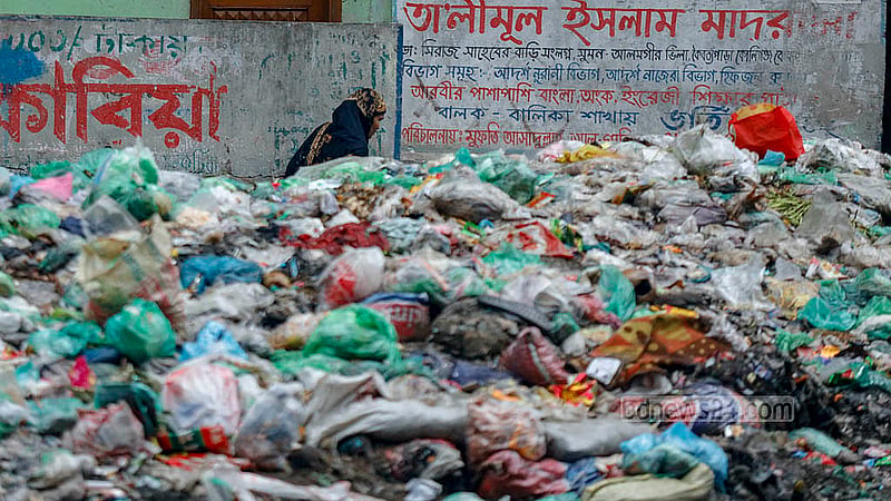 A footpath runs alongside the Shubhadda Canal in South Keraniganj, but the waste has piled up so high that in some places, it reaches the waist and even the chest of the person walking. Photo: Mahmud Zaman Ovi