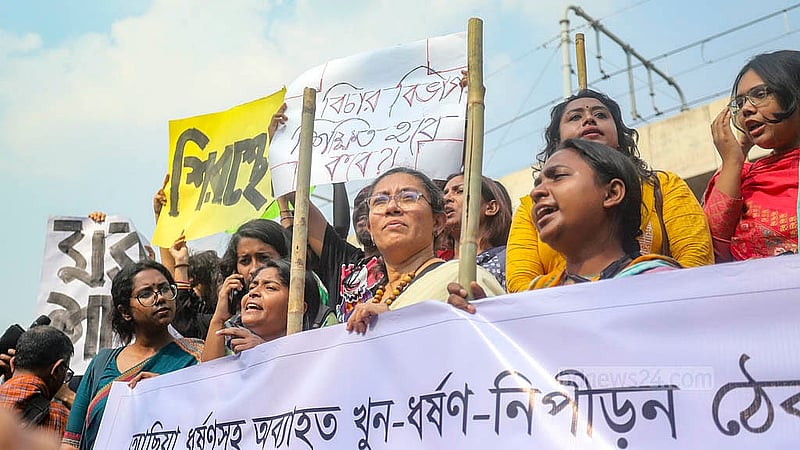 Dhaka University teachers and students, under the banner of the “Bangladesh Against Rape and Repression” platform, holding a baton march from the foot of Raju Sculpture. Photo: Abdullah al Momin