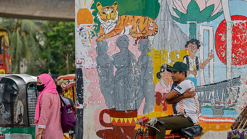 Posters were pasted over the artwork on the Kalshi Flyover commemorating the July Mass Uprising. Now, some of the posters have been removed, but the original look has yet to be restored. Photo: Mahmud Zaman Ovi