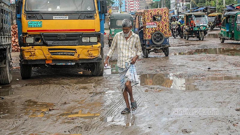 Pedestrians face severe inconvenience while crossing the damaged sections of the road from Hasnabad to Pangaon Container Terminal. Photo: Abdullah Al Momin