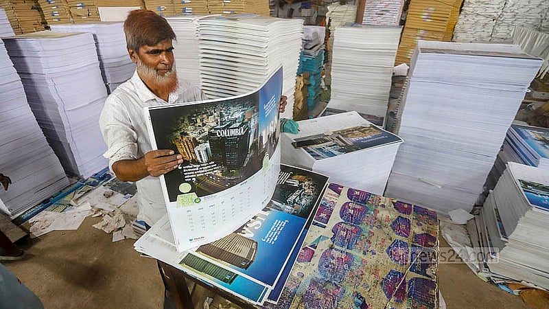 Printing of calendars for the New Year 2025 is under way at a house in Dhaka's Matuai. Photo: Abdullah al Momin