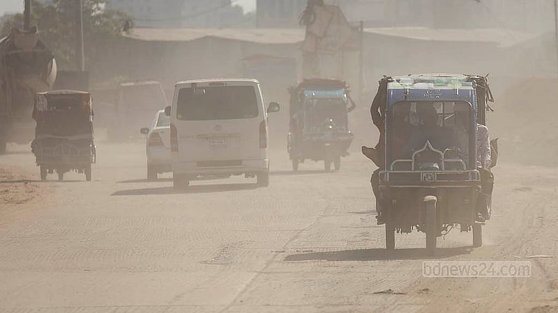 A battery-run auto-rickshaw moves through the cloud of dust on the Sadarghat-Gabtoli road in Dhaka. Passengers in the locality have to suffer due to extreme level of dust. Photo: Mahmud Zaman Ovi