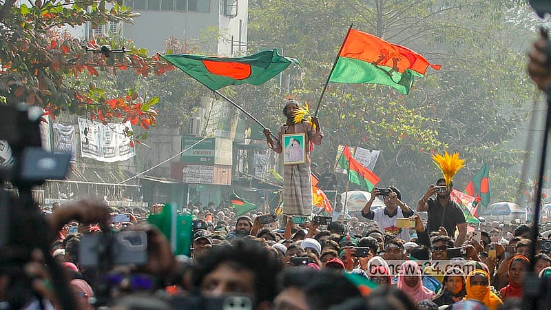 A supporter waves national and party flags at BNP Chairman Tarique Rahman’s rally outside Motijheel Ideal School and College on Monday, Feb 9, 2026, the final day of the election campaign. Photo: Abdullah Al Momin